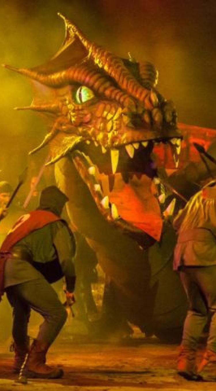 Een groep gewapende mannen confronteren de draak uit Joris en de Draak 